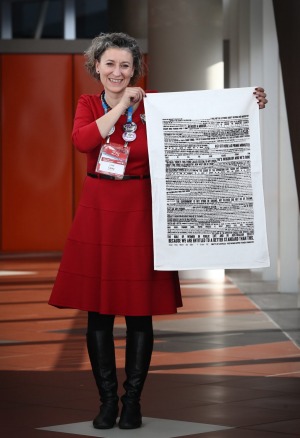 Lisa Carey, Emily's List national co-ordinator, holding one of the tea towels, says the group wants everyone to remember the speech "whatever they're doing".